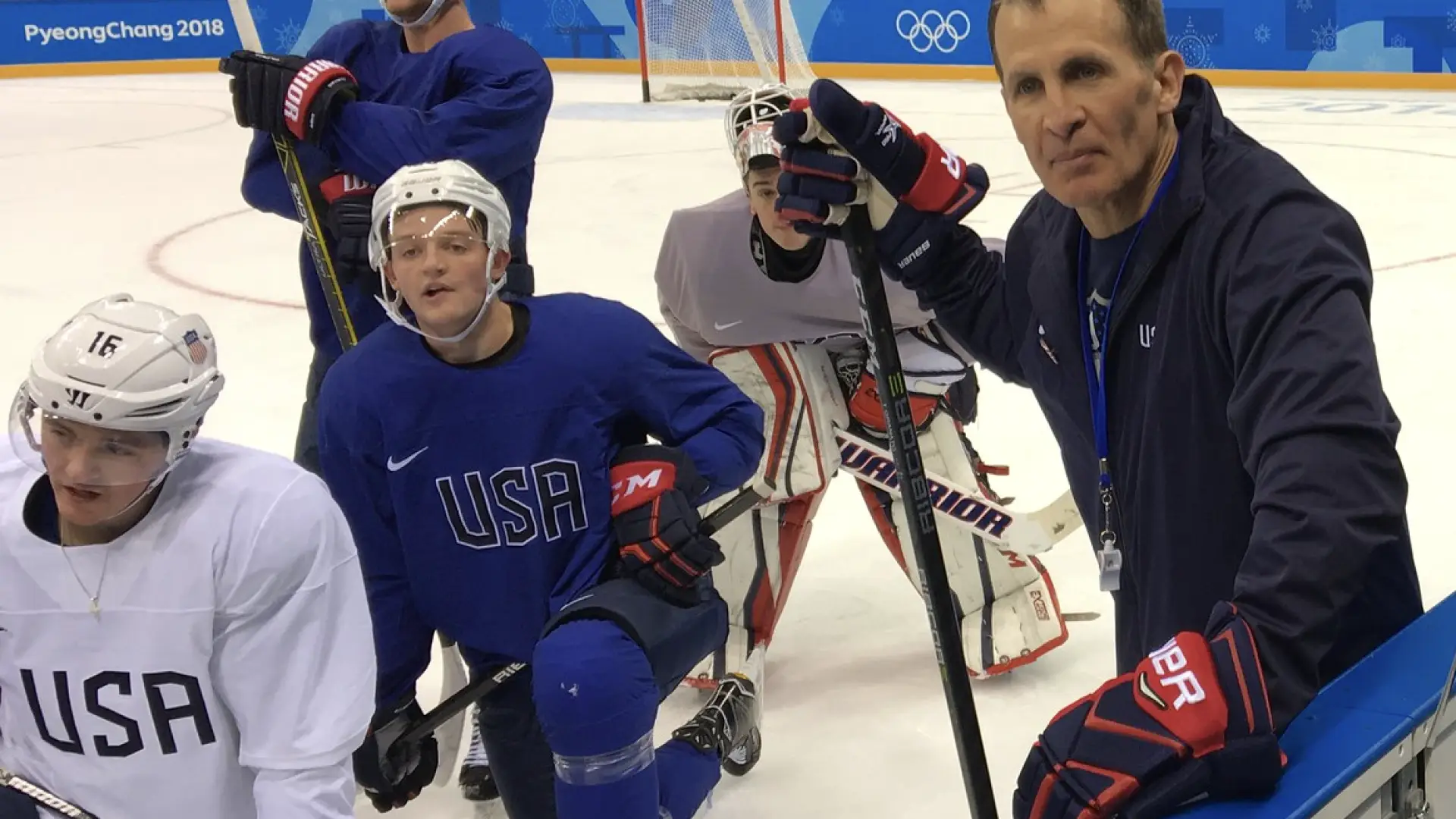 Olympic coach Tony Granato poses with USA hockey players.